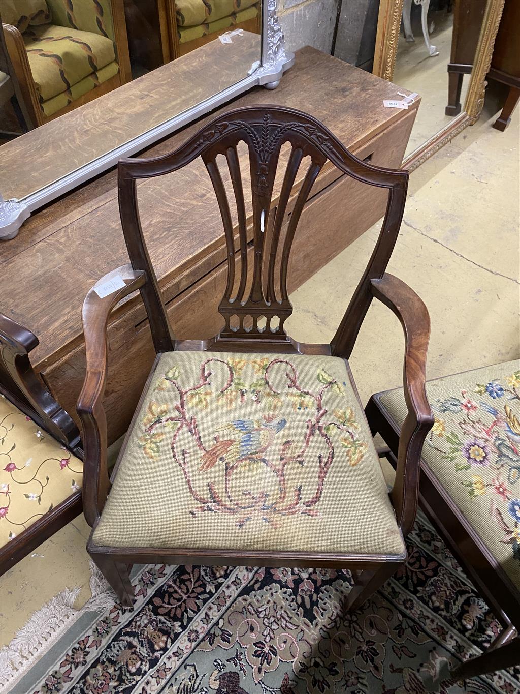 A set of six Hepplewhite style mahogany shield back dining chairs with tapestry drop in seats (two with arms)